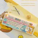 Whimsical claw machine keycap set, an intricate miniature arcade delight. This detailed angle showcases its playful design and tiny prizes perfectly.