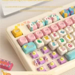 Close-up view of the whimsical claw machine keycap set, highlighting the detailed miniature arcade prizes and the playful transparent dome.