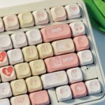 Vibrant PBT dye-sub Love Diary Valentine keycaps set, red and white with playful hearts and love motifs, shown from various angles for romantic flair.