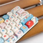 Various angles of Western Cat MOA PBT keycaps set. Playful cat cowboys in desert scenes highlight durable PBT material and MOA profile details.