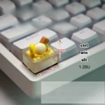 Charming handcrafted translucent yellow ice cream keycap, a playful miniature scoop with an edible aesthetic.