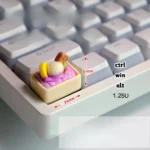 Whimsical handcrafted purple ice cream keycap, a realistic miniature scoop for your keyboard, adding a playful pop of color.