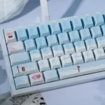 Winter Romance PBT Dye-Sub Keycaps Set displayed from multiple angles, featuring soft pastel blue and pink colors that evoke a cozy, serene aesthetic.