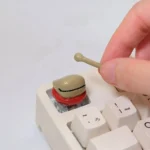 Detailed views of the Handcrafted Wooden Fish Keycaps, revealing its artistic wooden fish design and tranquil aesthetic from various angles.