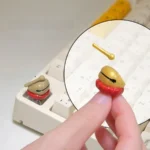 Artistic gallery view of the Handcrafted Wooden Fish Keycaps, highlighting its detailed wooden fish design and serene aesthetic from various angles.