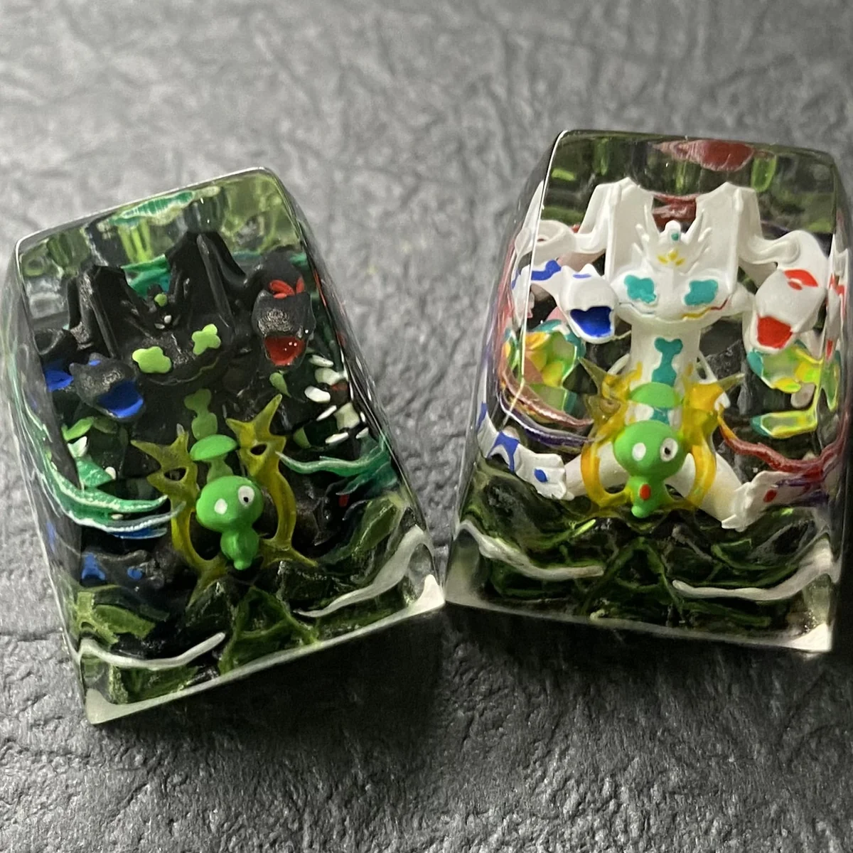 Close-up views of the handcrafted luminous resin Legendary Pokemon keycap, showcasing intricate sculptural details and vibrant translucent colors.