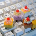 Delectable strawberry cream artisan keycap, handcrafted and shown from multiple angles, revealing its whimsical, vibrant, layered dessert fantasy.