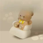 Whimsical Sofa Bear artisan keycap, intricately crafted resin featuring a charming miniature bear lounging on a tiny sofa.