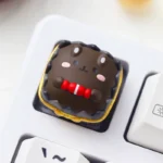 Another view of the whimsical chocolate animal artisan keycap, showcasing its charming handcrafted resin animal design and clear artistic finish.