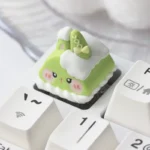 Whimsical handcrafted ESC artisan resin keycap. Adorable food creature with vibrant colors and intricate sculpted details, viewed from multiple angles.