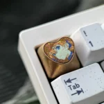 Handcrafted Asuka Titanium Heart ESC keycap gallery, showcasing its iconic red and orange colors, intricate heart motif, and lustrous metallic finish.