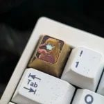 Exquisite Asuka Battle Suit Titanium Artisan Keycap, displaying vibrant Asuka character art on lustrous titanium alloy. A premium Asuka Keycap.