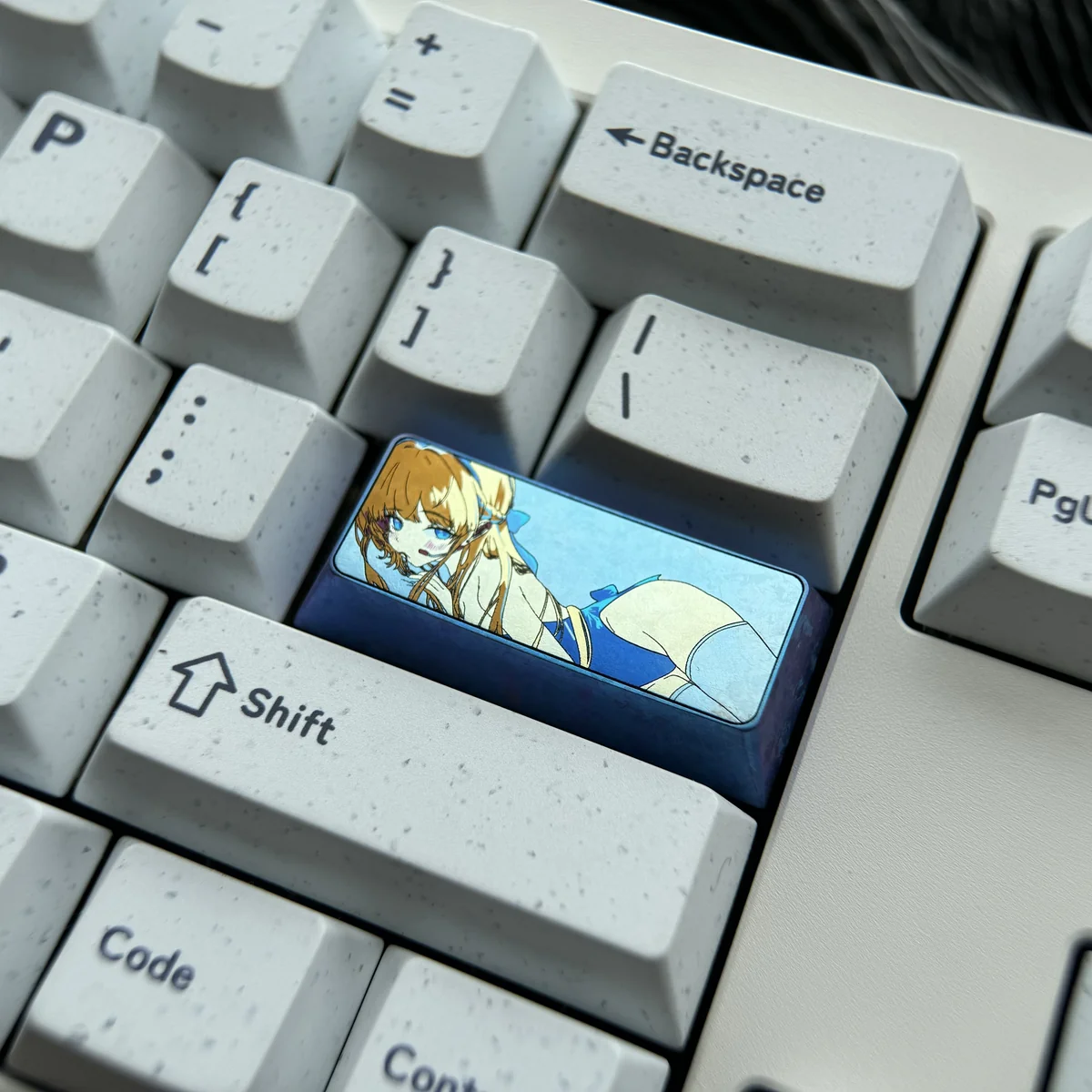 Meticulously crafted vibrant anodized Asuma Toki Titanium keycap 2.25U, showcasing its sleek metallic design and stunning multi-tone colors from various angles.