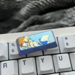 A gallery of meticulously crafted vibrant anodized Asuma Toki Titanium keycaps, showcasing sleek metallic designs and multi-tone colors from various angles.