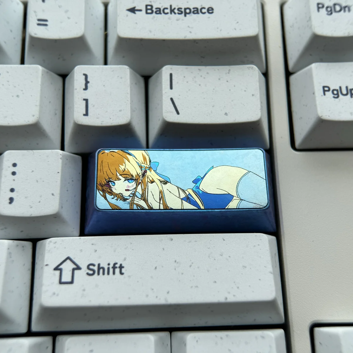 Gallery views of a meticulously crafted vibrant anodized Asuma Toki Titanium 2.25U keycap, highlighting sleek metallic design and dynamic multi-tone colors.