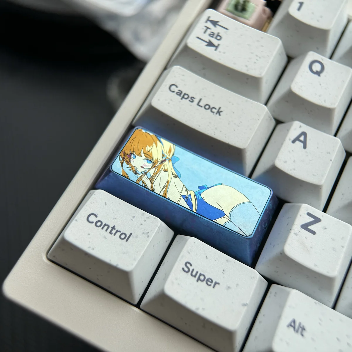 Meticulously crafted vibrant anodized Asuma Toki Titanium keycap shown from multiple angles, revealing its sleek metallic finish and dynamic multi-tone colors.