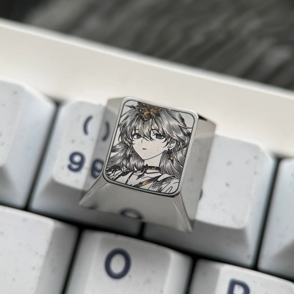 Exquisite Wuthering Waves Titanium Artisan Keycap showcasing intricate game character art with vibrant enamel-like coloring on polished metallic.