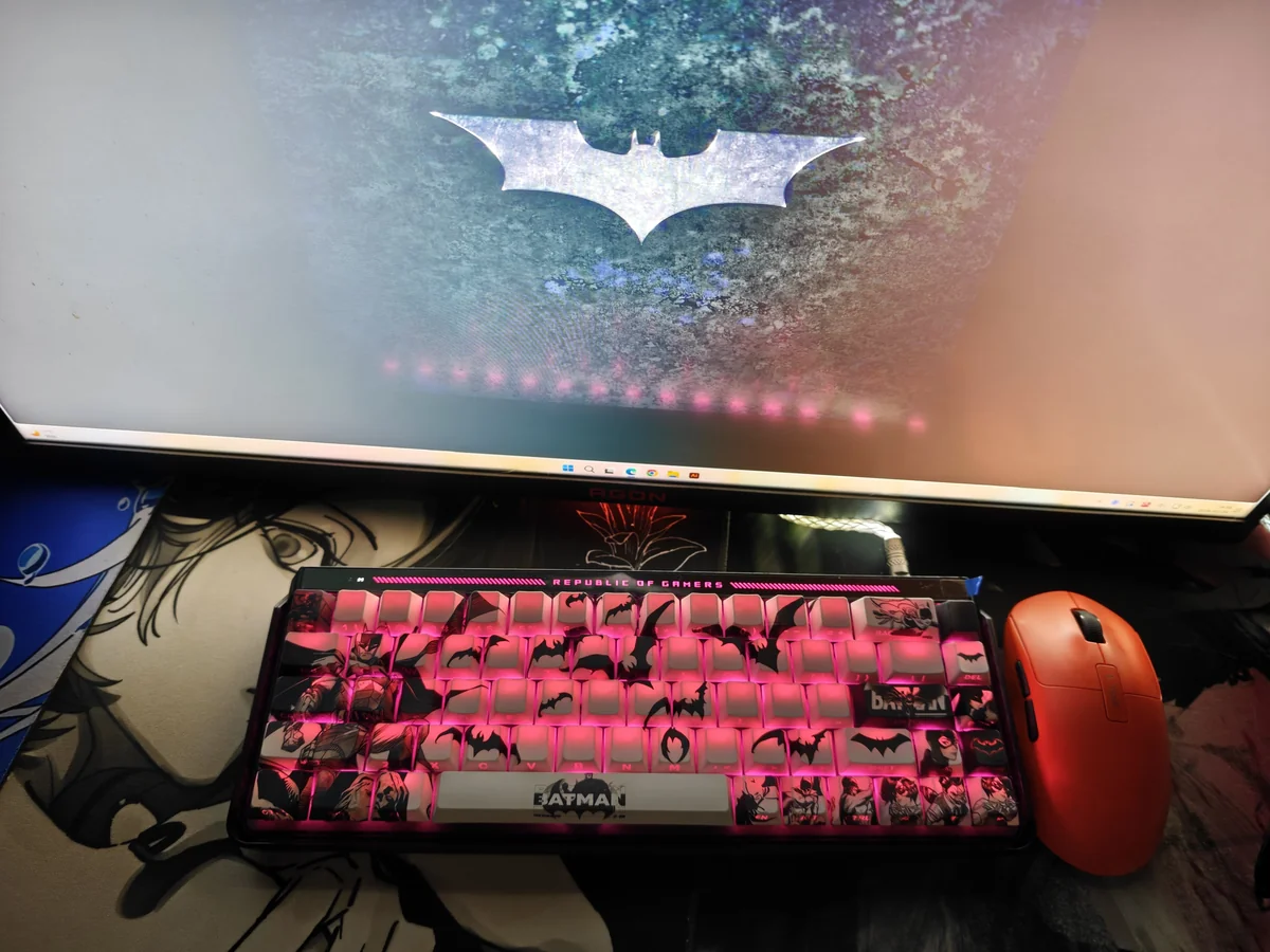 Iconic Batman side-engraved PBT keycaps set, viewed from multiple angles, reveal their subtle shine-through legends and dark, mysterious Gotham aesthetic.