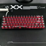 Close-up gallery of a Gothic Chrome Hearts frosted PC keycap set, highlighting its edgy design, translucent finish, and potential RGB glow from various angles.