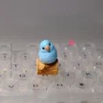 Exquisite handcrafted resin Blue Parrot Keycap, a vibrant sculptural art piece for MX boards, showcasing intricate detail.