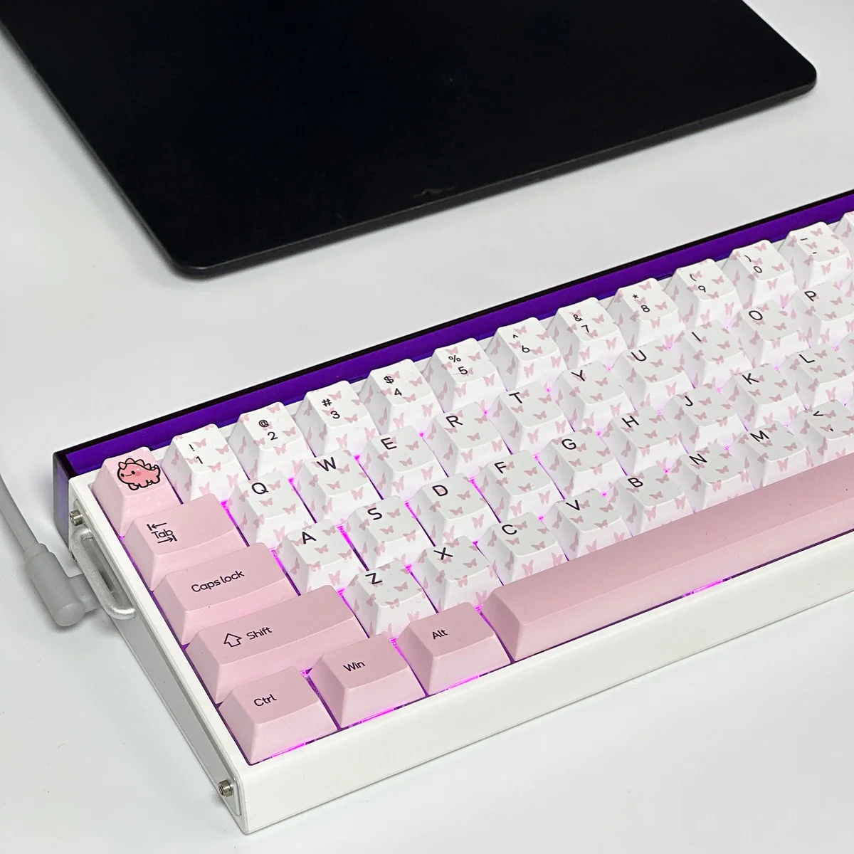 Charming Butterfly Heart-Shaped PBT keycaps set. Whimsical pink hues, dye-sublimated and shown from various angles on a pastel canvas.