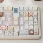 Adorable whimsical bear Cafe keycaps set, featuring charming cafe scenes and durable PBT with luminous PC, viewed from multiple angles.