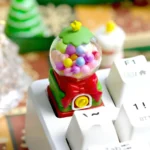 Close-up view of the nostalgic handcrafted resin candy machine keycap, highlighting its vibrant colors and intricate miniature retro art details.