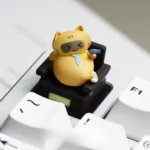 Detailed views of a handcrafted resin Cat Worker artisan keycap for the ESC key, showcasing its charming, playfully sculpted feline design.