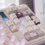 Good Night God Celestial Keycaps Set in shimmering translucent purple glitter, showcasing their ethereal stardust design from various artistic angles.