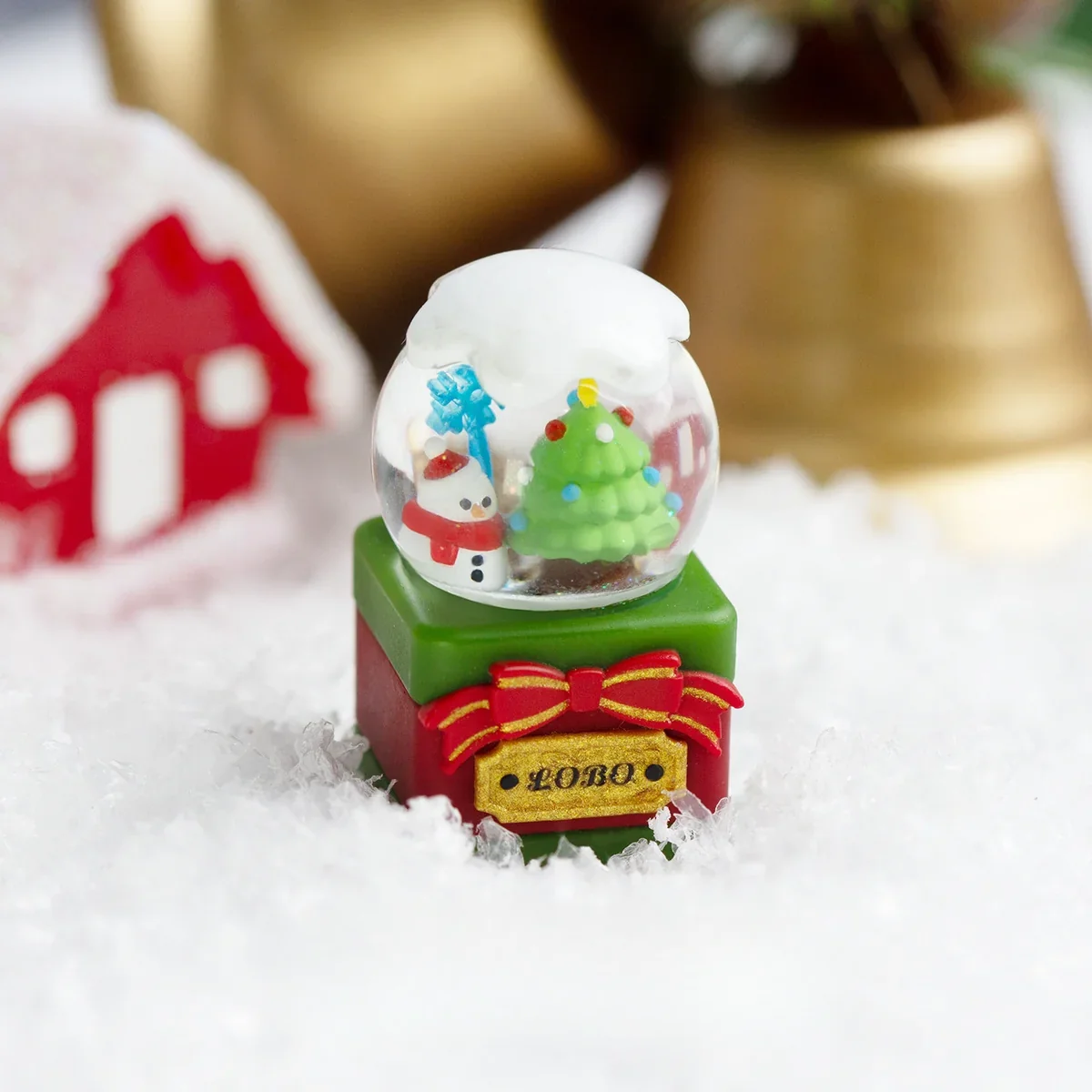 Gallery views of a handcrafted Christmas crystal Ball keycap, revealing the intricate miniature Christmas scene within its spherical resin from multiple argles.