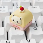 Vibrant handcrafted resin dessert bear keycap featuring adorable sweet bear charms, detailed from various angles. A playful artisan collectible for keyboard.
