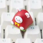 Vibrant handcrafted layered resin artisan keycap featuring adorable whimsical dessert mice, shown from a captivating side profile.