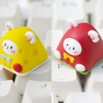 Whimsical handcrafted resin artisan keycap featuring adorable dessert mice nestled in vibrant layers, a unique ESC key.