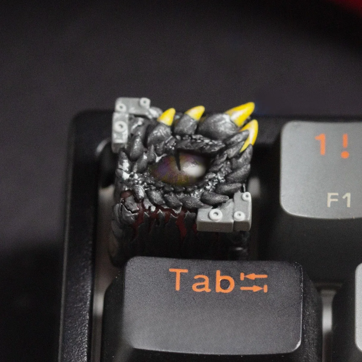 Detailed shot of the mystical Dragon Eye Keycap, revealing the handcrafted resin's translucent depth and glowing reptilian eye with intricate scale design.