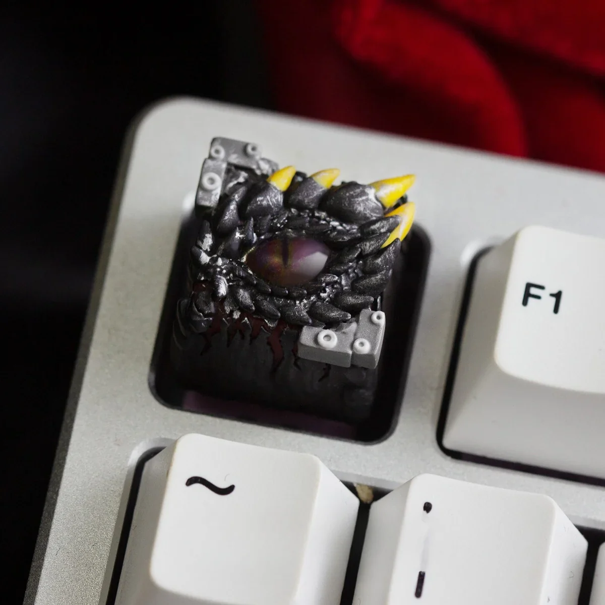 Mystical Dragon Eye Keycap, handcrafted resin featuring a captivating, glowing translucent reptilian eye and intricate scales.