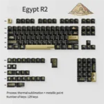 Close-up views of the exquisite Egypt Black & Gold PBT keycap set, highlighting intricate hieroglyphs and the luxurious metallic finish from multiple angles.
