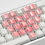 Ethereal translucent ceramic supplement keycaps set featuring delicate cherry blossoms and graceful butterflies, showcasing exquisite artisan craftsmanship.