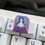 Iconic Misato Katsuragi Evangelion titanium keycap from multiple angles, highlighting its sleek finish, vibrant character art, and premium details.