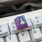 Multiple angles of the iconic Misato Katsuragi Evangelion titanium keycap, showcasing its sleek finish and vibrant character art. A premium collectible setup.