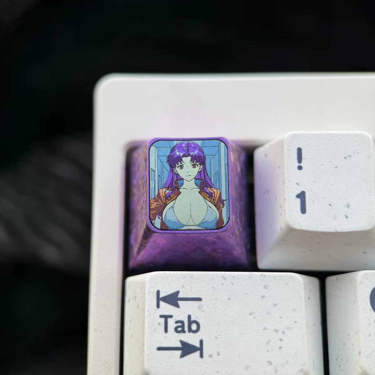The iconic Misato Katsuragi Evangelion titanium keycap, a premium art piece with vibrant anime character detail and a sleek finish.