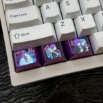 Premium Frieren Fern titanium artisan keycaps, intricately designed with anime characters, displayed from multiple angles to highlight the anodized titanium material.