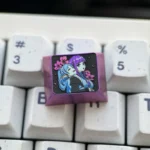 Premium Frieren Fern titanium artisan keycap, prominently displaying intricate anime character designs on anodized titanium. A stunning Frieren keycap.