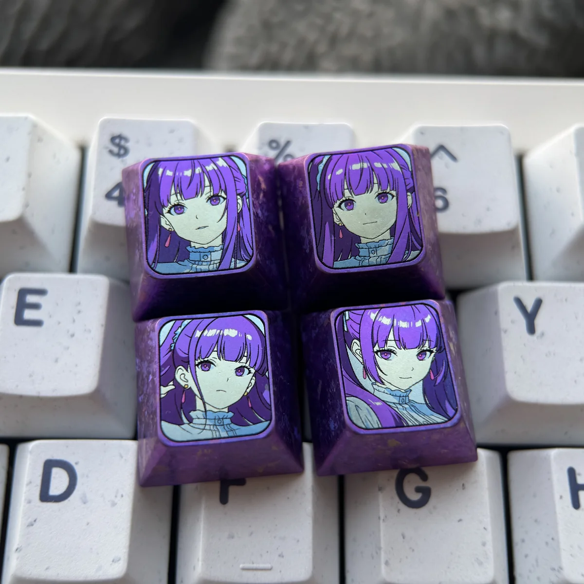 Exquisite Frieren titanium artisan keycap, showcasing vibrant anodized colors and luxurious texture for an enchanting accent on your keyboard.