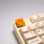 Whimsical handcrafted 3D artisan keycap featuring a miniature grid cake design from a new angle, showcasing vibrant details.