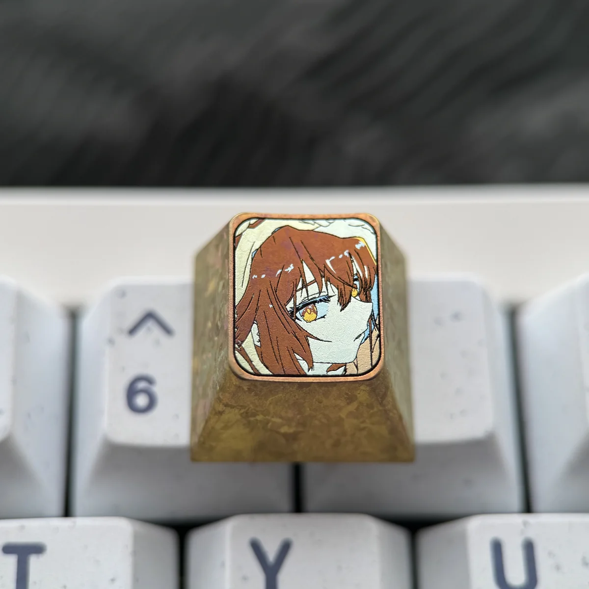 Multiple angles of the premium Haibara Ai titanium ESC keycap, showcasing its meticulously etched iconic imagery and polished finish.