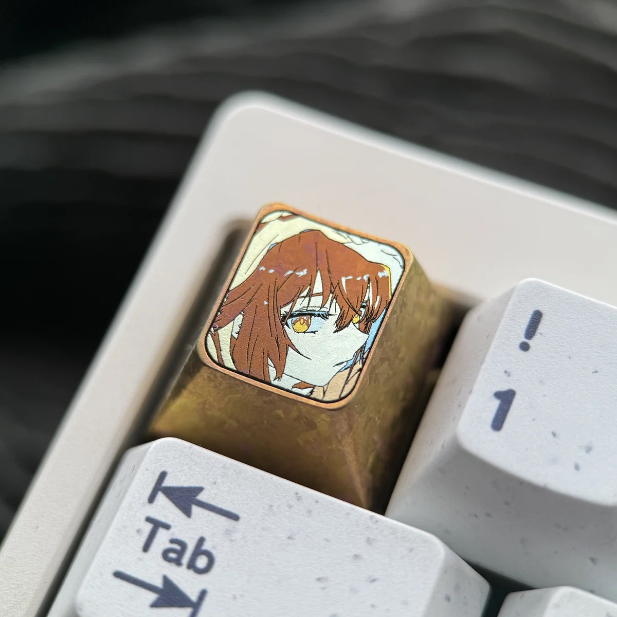 Close-up view of the premium Haibara Ai titanium ESC keycap from multiple angles, showcasing the meticulously etched iconic imagery on polished titanium.