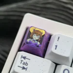 Multiple angles of the premium titanium Haibara Ai ESC keycap, showcasing the meticulously etched Detective Conan character art on polished metallic.