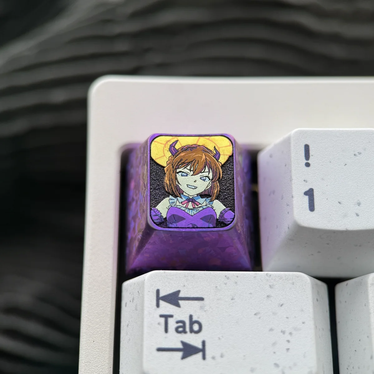 Close-up views of the premium Haibara Ai titanium ESC keycap, showcasing its meticulously etched iconic design from multiple artistic angles.