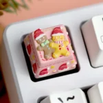 Close-up of a handcrafted Christmas resin ESC keycap, showcasing its whimsical 3D festive scene from multiple artistic angles with vibrant holiday design.