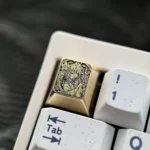 Close-up gallery views of the Hatsune Miku Brass Artisan Keycap, highlighting intricate engravings and polished Brass from various angles.